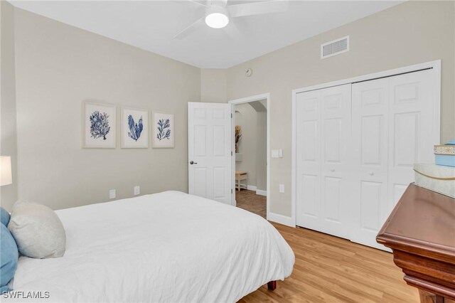 bedroom featuring hardwood / wood-style flooring, a closet, and ceiling fan