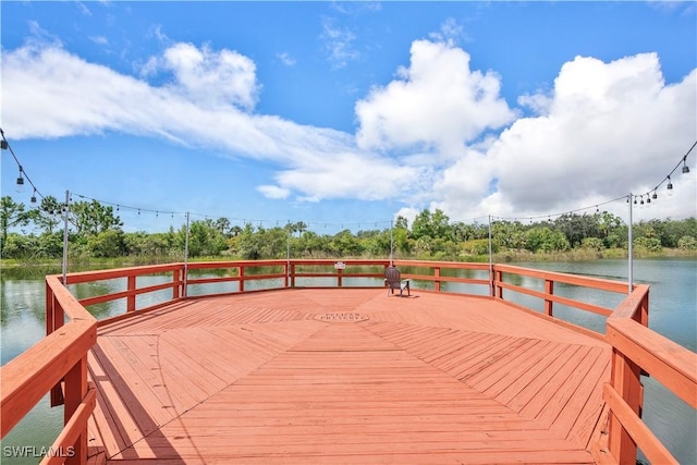 view of dock with a deck with water view