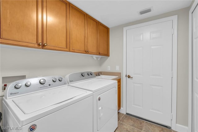 laundry room with washer and dryer, cabinets, and sink