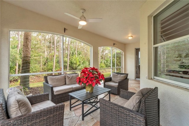 sunroom with ceiling fan and a wealth of natural light