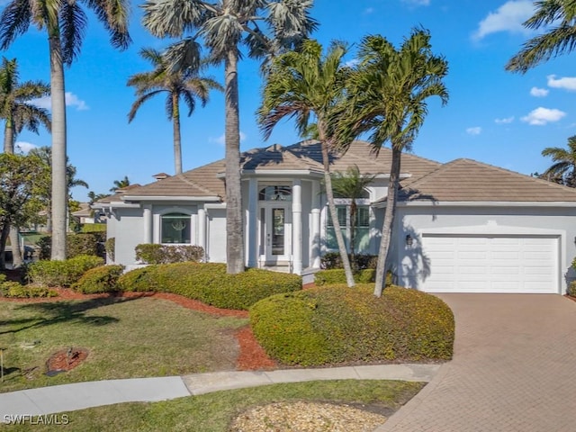 view of front facade with a front lawn and a garage