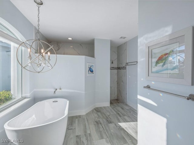 bathroom featuring separate shower and tub and a notable chandelier