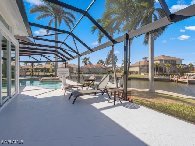 view of patio featuring a water view and a lanai