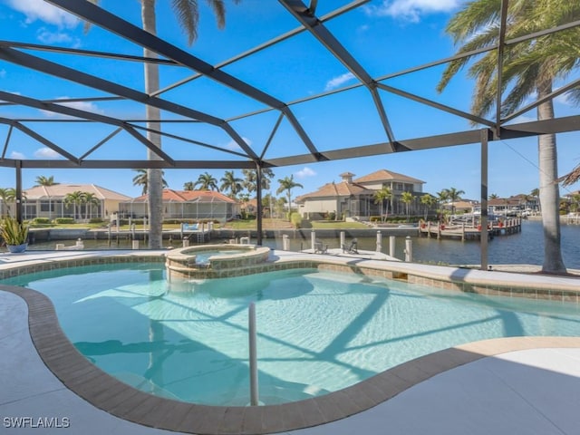 view of pool with an in ground hot tub, a water view, and a lanai