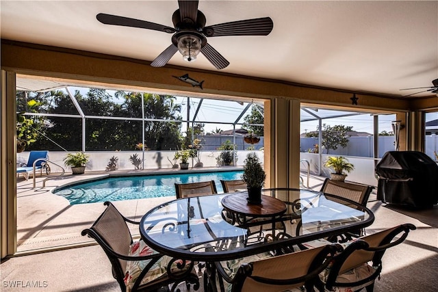 view of pool with ceiling fan and a grill