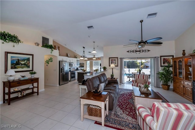 tiled living room featuring ceiling fan and vaulted ceiling