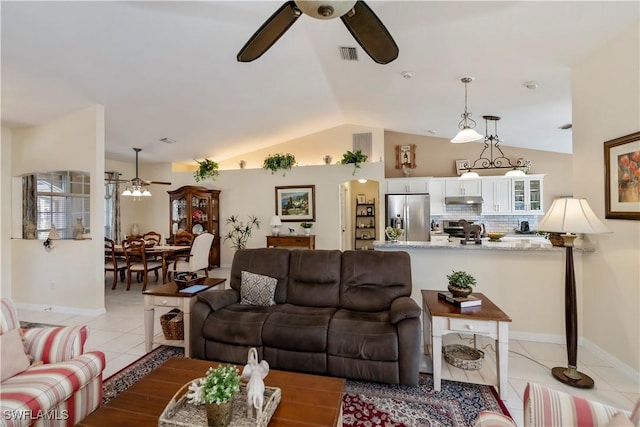 living room featuring ceiling fan, light tile patterned flooring, and lofted ceiling