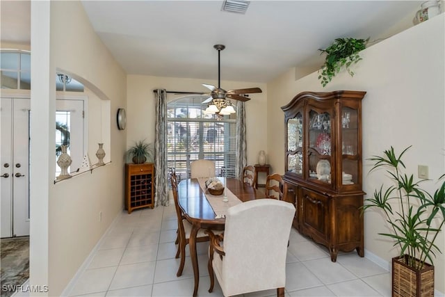 tiled dining space featuring ceiling fan