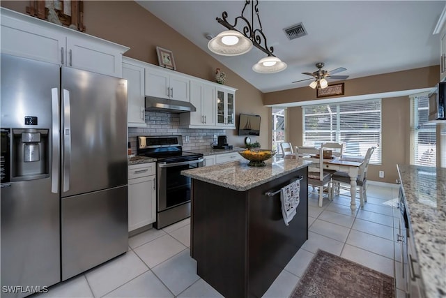 kitchen featuring stainless steel appliances, white cabinetry, a center island, and lofted ceiling