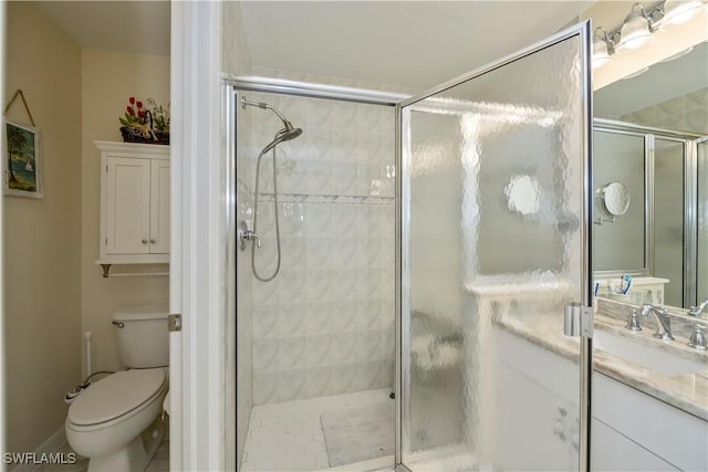 bathroom with toilet, walk in shower, and vanity