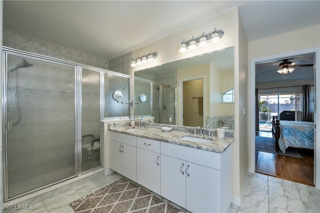 bathroom featuring vanity, ceiling fan, and walk in shower