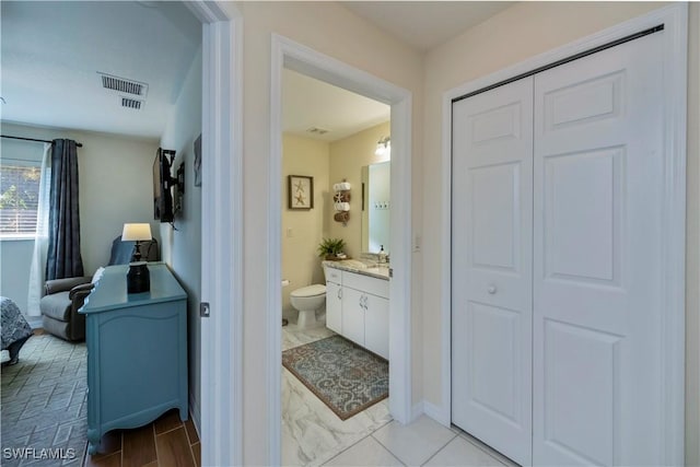 bathroom featuring toilet and vanity