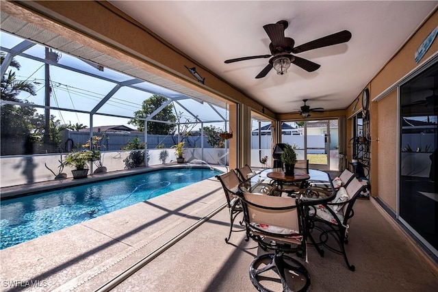 view of pool featuring ceiling fan, a patio, and glass enclosure