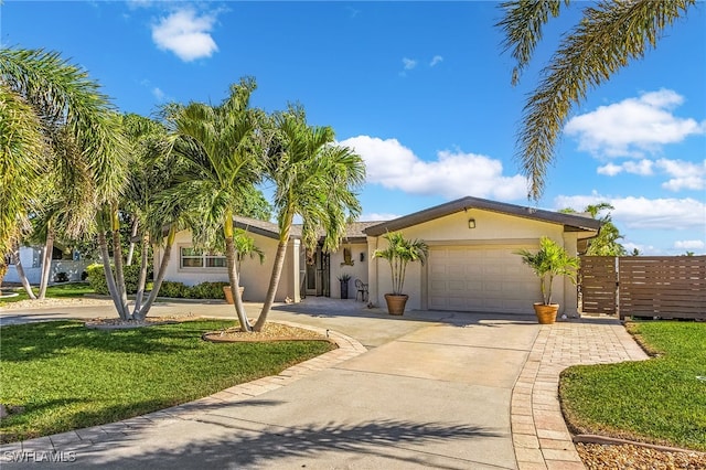 ranch-style home featuring a garage and a front lawn