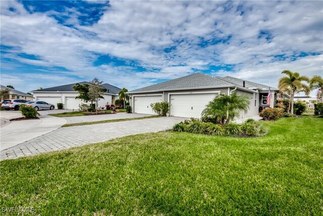 view of front of home with a garage and a front lawn