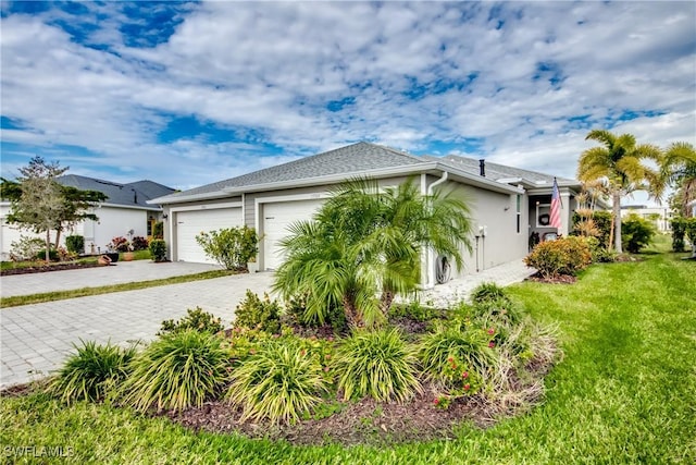 view of property exterior with a lawn and a garage