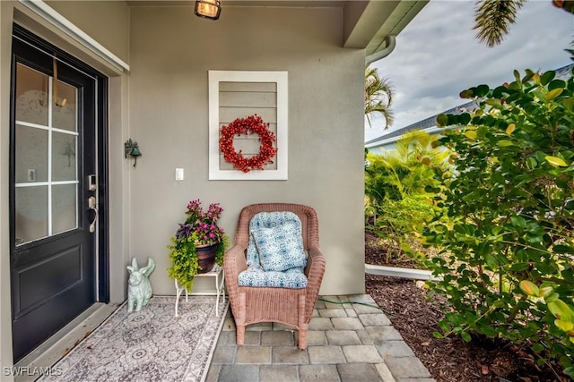 property entrance with stucco siding