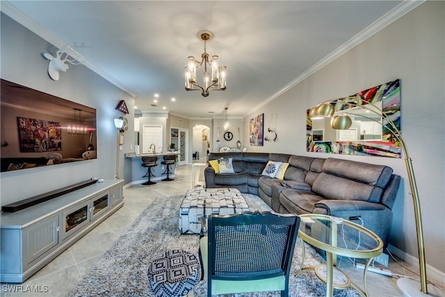 living room featuring light tile patterned floors, baseboards, a chandelier, and ornamental molding