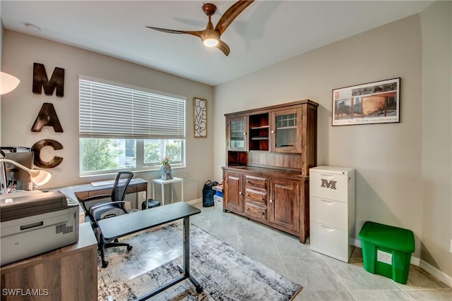 home office with ceiling fan and baseboards