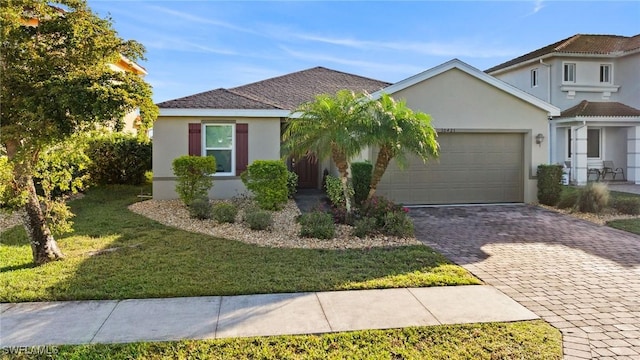 10421 Canal Brook Ln, Lehigh Acres, FL 33936 - view of front facade featuring a front lawn and a garage