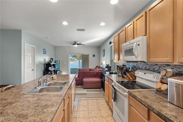 kitchen with ceiling fan, sink, light brown cabinets, backsplash, and white appliances