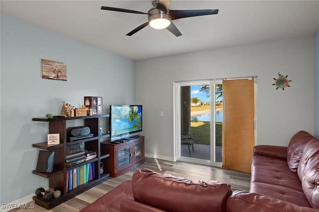 living room featuring hardwood / wood-style flooring and ceiling fan