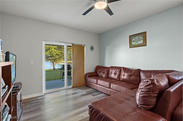 living room featuring light hardwood / wood-style flooring and ceiling fan