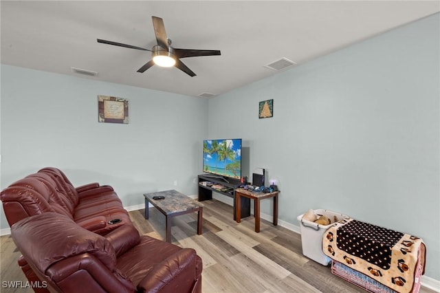 living room featuring ceiling fan and light wood-type flooring