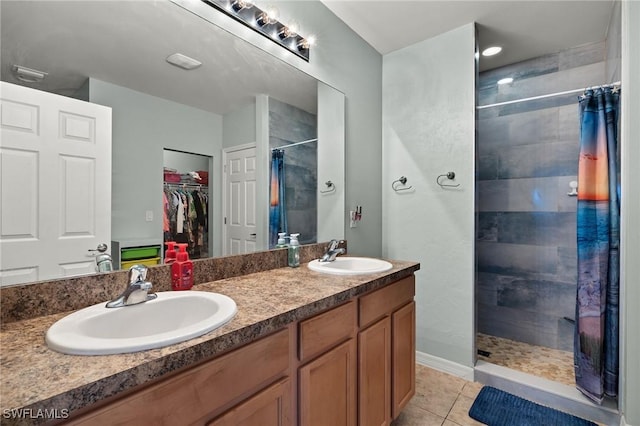 bathroom with a shower with curtain, vanity, and tile patterned floors