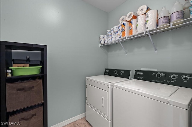 washroom with washer and clothes dryer and light tile patterned flooring