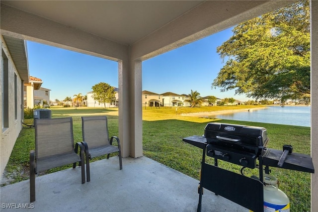 view of patio / terrace with a water view, grilling area, and central AC