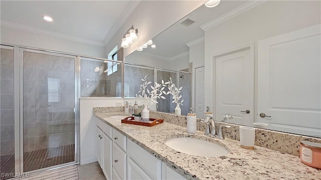 bathroom featuring vanity, a shower with door, tile patterned flooring, and ornamental molding