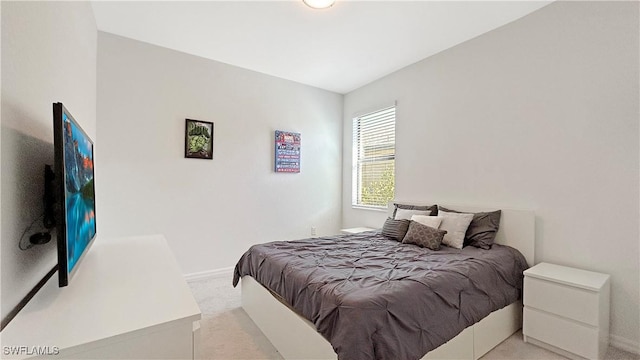 bedroom featuring light colored carpet