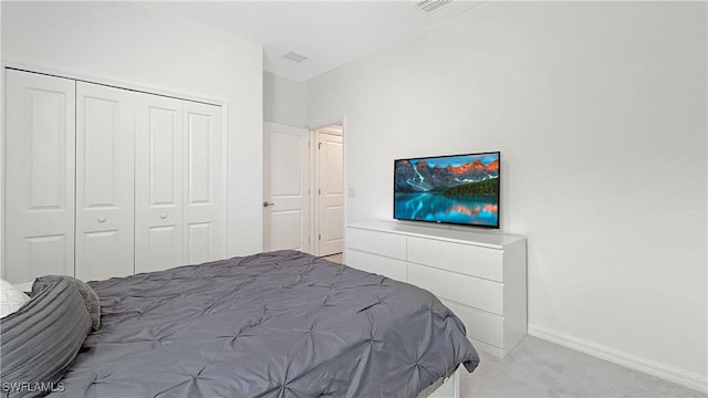 bedroom with a closet and light carpet