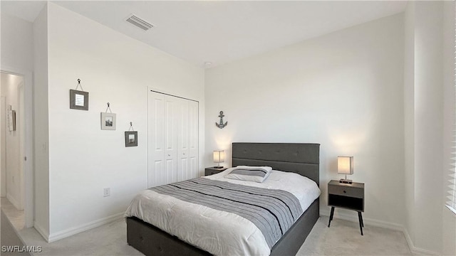 bedroom with light colored carpet and a closet