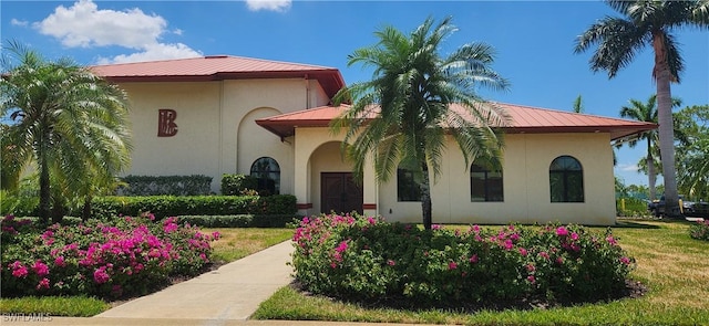 mediterranean / spanish-style house featuring a front yard