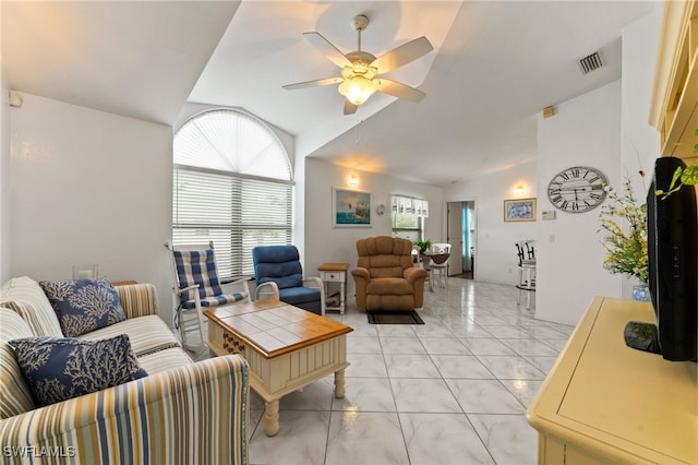 living room featuring ceiling fan and vaulted ceiling