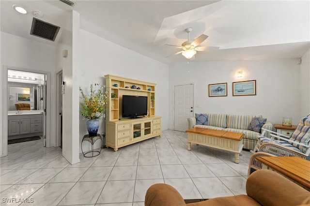 living room with ceiling fan and vaulted ceiling