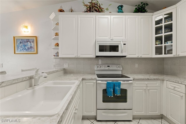 kitchen featuring white appliances, white cabinetry, and sink