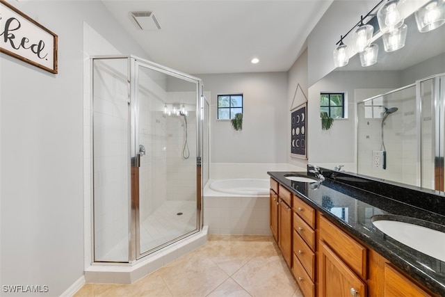 full bath with visible vents, a sink, tile patterned flooring, a shower stall, and a bath