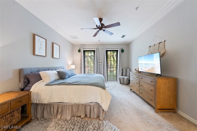 bedroom with visible vents, crown molding, baseboards, light colored carpet, and ceiling fan