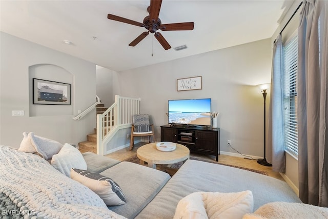 living room featuring ceiling fan and plenty of natural light