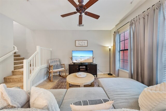 tiled living room with ceiling fan