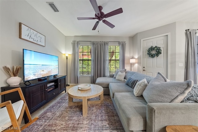 living area with visible vents and ceiling fan