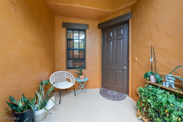 entrance to property with stucco siding