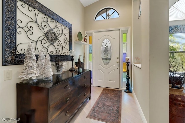 foyer with a wealth of natural light and a towering ceiling