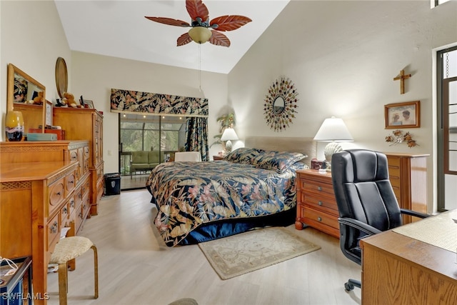 bedroom featuring vaulted ceiling, ceiling fan, light wood-type flooring, and multiple windows