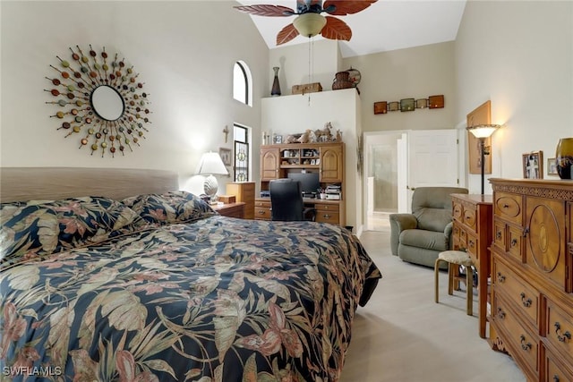 carpeted bedroom featuring high vaulted ceiling, ensuite bath, and ceiling fan