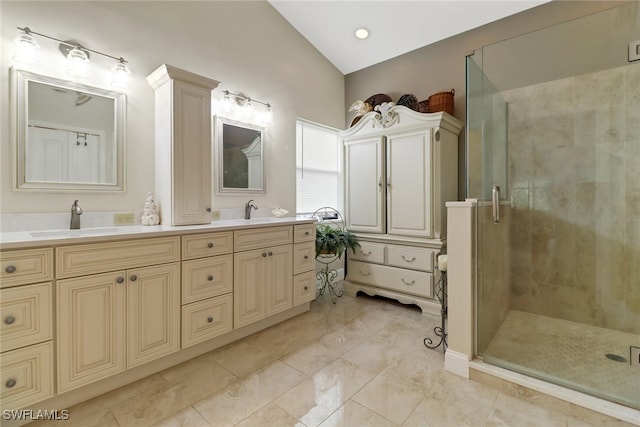 bathroom featuring a shower with door, lofted ceiling, and vanity