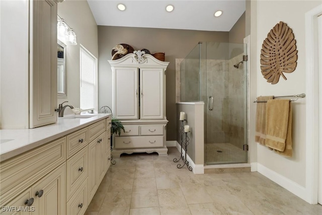 bathroom with a shower with door and vanity